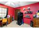 Cozy bedroom with a closet, a desk, a window, shelving, and an accent wall at 5272 Cumberland Way, Stone Mountain, GA 30087