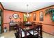 Inviting dining room features hardwood floors, wood trim, a chandelier, a piano, and an accent wall at 5272 Cumberland Way, Stone Mountain, GA 30087