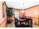 Charming dining room features hardwood floors, wood trim, a large window, chandelier, and an accent wall at 5272 Cumberland Way, Stone Mountain, GA 30087