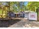 Quaint blue home with attached garage boasts a beautiful yard and inviting curb appeal at 5272 Cumberland Way, Stone Mountain, GA 30087