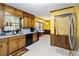 Well-lit kitchen with wood cabinets, white countertops, and adjacent dining area at 5272 Cumberland Way, Stone Mountain, GA 30087