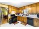 Functional kitchen with ample wooden cabinetry, white countertops, and black appliances at 5272 Cumberland Way, Stone Mountain, GA 30087