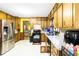 Bright kitchen features wooden cabinets, white countertops, stainless steel refrigerator, and black appliances at 5272 Cumberland Way, Stone Mountain, GA 30087