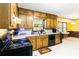Traditional kitchen features wooden cabinets, white countertops, black appliances, and a bright eating area at 5272 Cumberland Way, Stone Mountain, GA 30087