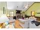 Comfortable living room featuring a brick fireplace, hardwood floors, and bright, sunny windows at 5272 Cumberland Way, Stone Mountain, GA 30087