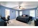 Spacious main bedroom features a ceiling fan, a window, and an ensuite bathroom at 5272 Cumberland Way, Stone Mountain, GA 30087