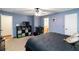 Bright main bedroom features a ceiling fan, an ensuite bathroom, shelving, and a window at 5272 Cumberland Way, Stone Mountain, GA 30087