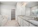 Luxurious bathroom with double sinks, granite countertops, soaking tub, and walk-in closet at 811 Corsiglia Farm, Marietta, GA 30060