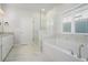 Elegant bathroom featuring a soaking tub, glass-enclosed shower, and double vanity with granite countertops at 811 Corsiglia Farm, Marietta, GA 30060