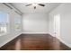 Spacious bedroom with three windows, ceiling fan, and hardwood floors at 811 Corsiglia Farm, Marietta, GA 30060