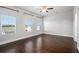 Spacious bedroom with three windows, ceiling fan, and hardwood floors at 811 Corsiglia Farm, Marietta, GA 30060
