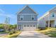 Charming two-story home with a blue exterior, attached garage, and well-manicured lawn at 811 Corsiglia Farm, Marietta, GA 30060