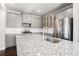 Modern kitchen with granite countertops, stainless steel appliances, and stylish gray cabinetry, offering ample storage at 811 Corsiglia Farm, Marietta, GA 30060
