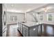 Modern kitchen with granite countertops, gray cabinetry, stainless steel appliances, and an island with a sink at 811 Corsiglia Farm, Marietta, GA 30060