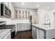 Well-equipped kitchen with stainless steel appliances, gray cabinets, granite counters, and a stylish subway tile backsplash at 811 Corsiglia Farm, Marietta, GA 30060
