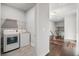 Convenient laundry area near hardwood hallway, complete with washer, dryer, and overhead shelving at 811 Corsiglia Farm, Marietta, GA 30060