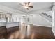 Bright open-concept living space with hardwood floors, flowing into a modern kitchen and featuring a staircase at 811 Corsiglia Farm, Marietta, GA 30060