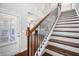 Elegant staircase featuring dark wood treads, white risers, and a decorative metal railing at 811 Corsiglia Farm, Marietta, GA 30060