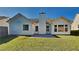 Backyard of house featuring a flat grassy yard, white siding, and patio at 145 Charleston Pl, Covington, GA 30016