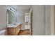 Bathroom features a single vanity, updated lighting and wood-look flooring at 145 Charleston Pl, Covington, GA 30016