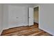 Bedroom features wood-look flooring, closet with doors, and an attached bathroom at 145 Charleston Pl, Covington, GA 30016