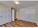 Bedroom features wood-look flooring, closet with doors, and an attached bathroom at 145 Charleston Pl, Covington, GA 30016