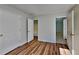 Bedroom features wood-look flooring, closet with doors, and an attached bathroom at 145 Charleston Pl, Covington, GA 30016