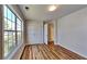 Bright bedroom features wood-look flooring, large windows, and closet with double doors at 145 Charleston Pl, Covington, GA 30016
