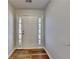 Inviting entryway featuring beautiful wood floors and a modern front door with sidelights at 145 Charleston Pl, Covington, GA 30016