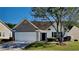 Charming single-story home featuring a brick facade, manicured lawn, and attached two-car garage at 145 Charleston Pl, Covington, GA 30016