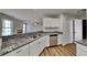 Kitchen showcasing stainless steel appliances, white cabinets, and granite countertops at 145 Charleston Pl, Covington, GA 30016