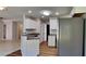 Well-lit kitchen with white cabinets, gray countertops and stainless-steel refrigerator at 145 Charleston Pl, Covington, GA 30016