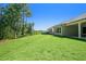 Large, grassy backyard with a covered patio, offering a serene view at 2013 Ripple Park Bnd, Canton, GA 30114