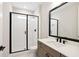 Bathroom featuring a glass shower, modern sink and vanity with black fixtures, and stylish mirror at 2013 Ripple Park Bnd, Canton, GA 30114