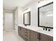 This bathroom features a double vanity with dark cabinets, white countertops, and dark fixtures at 2013 Ripple Park Bnd, Canton, GA 30114