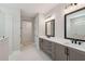 Bathroom with double vanity, modern lighting fixtures, and a large mirror at 2013 Ripple Park Bnd, Canton, GA 30114