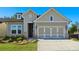 Charming home featuring a two-car garage and a neatly landscaped front yard at 2013 Ripple Park Bnd, Canton, GA 30114