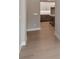 Hallway leading to a spacious kitchen, showcasing modern flooring and neutral tones at 2013 Ripple Park Bnd, Canton, GA 30114