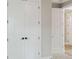 Hallway with white doors and black hardware in a newly constructed home at 2013 Ripple Park Bnd, Canton, GA 30114