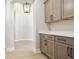 Hallway with decorative pendant lighting leads to laundry area featuring light wood cabinets and white countertop at 2013 Ripple Park Bnd, Canton, GA 30114