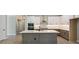 Bright, open kitchen with white cabinets, stainless steel appliances, and an island with quartz countertops at 2013 Ripple Park Bnd, Canton, GA 30114