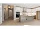 Open-concept kitchen featuring white cabinets, a large island with pendant lights, and modern appliances at 2013 Ripple Park Bnd, Canton, GA 30114