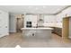 Open-concept kitchen featuring white cabinets, a large island with bar seating, and modern appliances at 2013 Ripple Park Bnd, Canton, GA 30114
