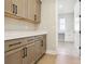 Bright laundry room features wooden cabinets, white countertops, and an adjacent washing area at 2013 Ripple Park Bnd, Canton, GA 30114