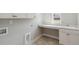 Clean laundry room with white cabinets, sink, and open space; ready for appliances at 2013 Ripple Park Bnd, Canton, GA 30114