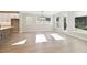 Sunlit living room features hardwood floors, modern lighting, and a seamless transition to the kitchen at 2013 Ripple Park Bnd, Canton, GA 30114