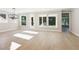 Sunlit living room with hardwood floors and large windows providing natural light and backyard views at 2013 Ripple Park Bnd, Canton, GA 30114