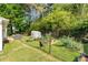 Spacious backyard featuring a lush garden, greenhouse, and secure fencing for outdoor enjoyment at 2014 Anchor Way, Buford, GA 30518