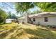 Expansive backyard with patio, landscape beds, and mature trees offering privacy and outdoor living at 2014 Anchor Way, Buford, GA 30518