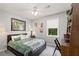 This bedroom is complete with a ceiling fan, window, desk, dresser, and a comfortable bed at 2014 Anchor Way, Buford, GA 30518